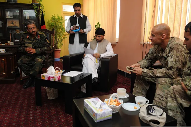 U.S. Navy Cmdr. Louis McCray, right, the commanding officer of the Farah Provincial Reconstruction Team (PRT), takes part in a discussion with Farah leaders, including Farah provincial Gov. Mohammed Akram Khpalwak, center seated, and Afghan National Army Col. Asadullah Kohistani, left, during a meet. Team history decides how leadership influence actually lands