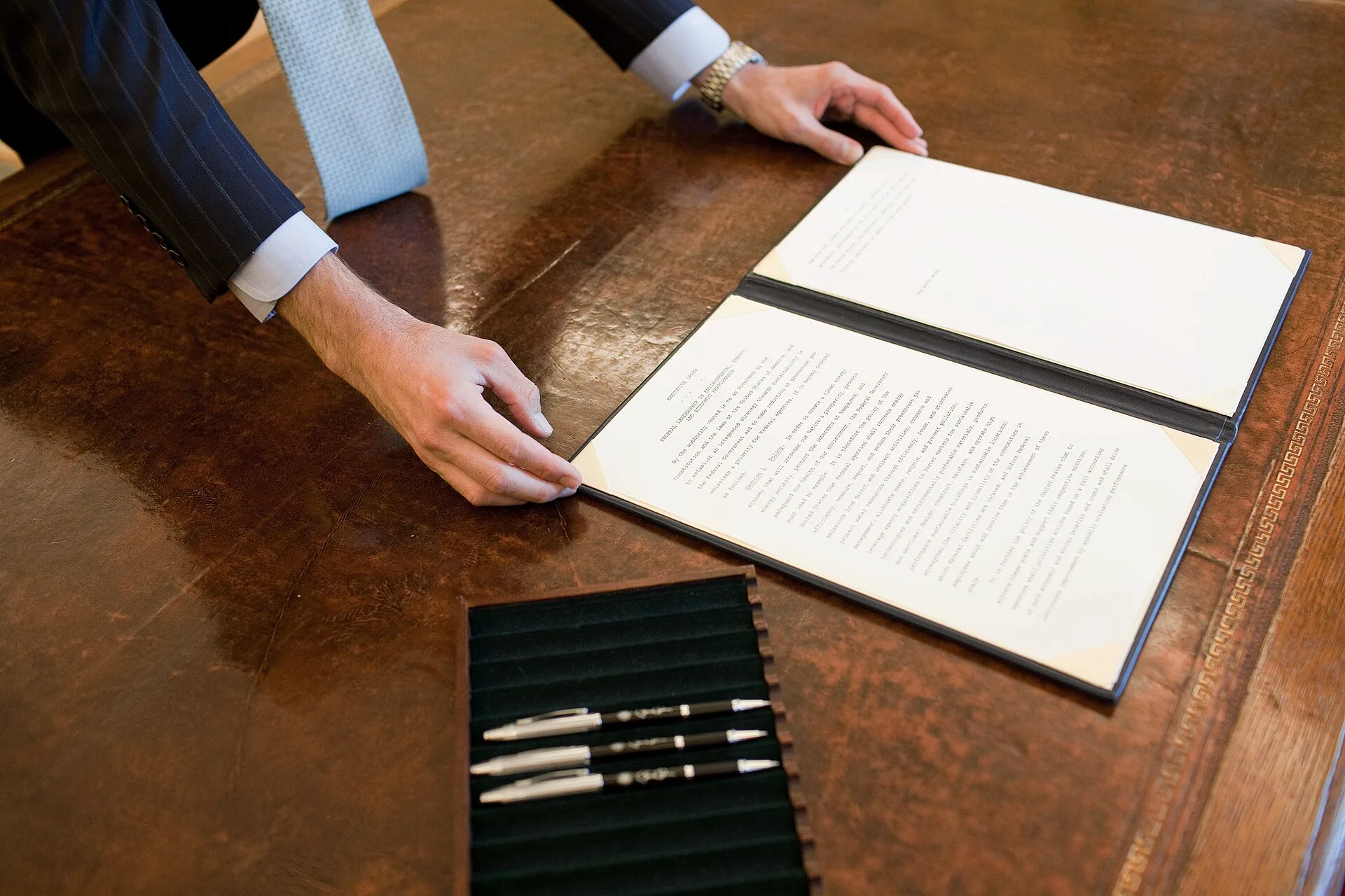 A staff member positions the Council of Environoment Quality (CEQ) Executive Order on President Barack Obama's desk prior to his signing the document in the Oval Office, Oct. 5, 2009. (Official White House Photo by Pete Souza). Leadership Job Offer Salary Negotiation: Why Order Matters