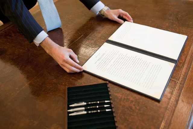 A staff member positions the Council of Environoment Quality (CEQ) Executive Order on President Barack Obama's desk prior to his signing the document in the Oval Office, Oct. 5, 2009. (Official White House Photo by Pete Souza). Leadership Job Offer Salary Negotiation: Why Order Matters